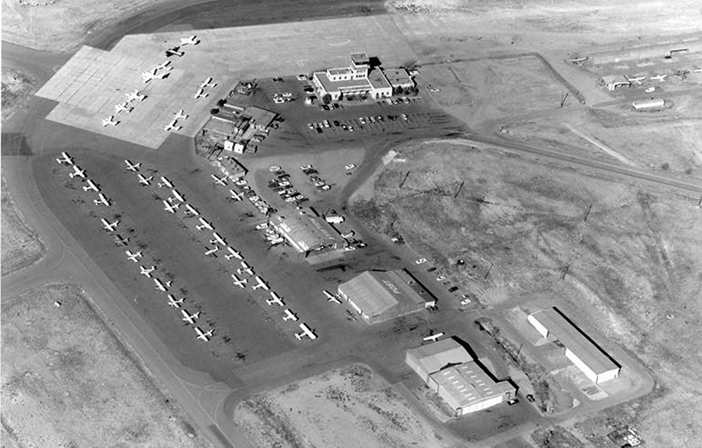 Aerial view of the Santa Fe airport in 1985. The terminal building, built in 1957 and still in use today, is near the top center. The old original terminal is the first building directly to the left.