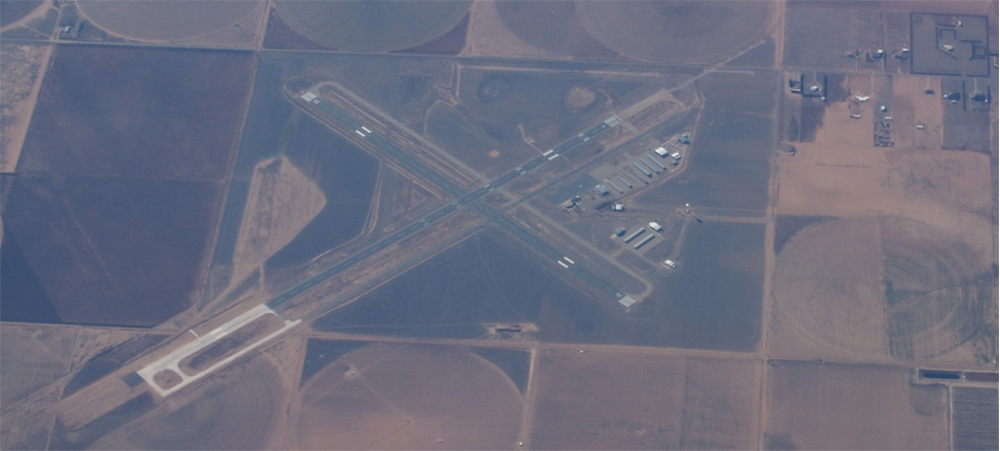 An aerial view of the Clovis airport in 2013 looking south and showing the concrete extension of runway 04-22 in the lower left.