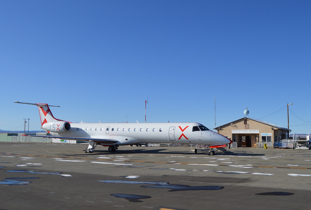 JSX Air Embraer 145 in front of the Taos airport terminal in 2022.